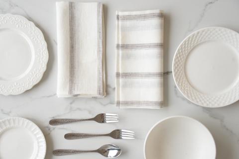 Elegant 100% linen napkins neatly placed on a dining table, eco-friendly and reusable