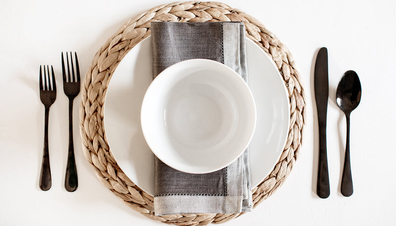 Minimalist place setting featuring grey linen table napkin - perfect for modern table linens