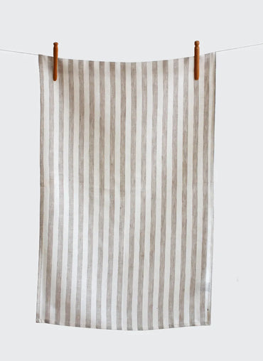 Striped towel hanging on a clothesline against a white background