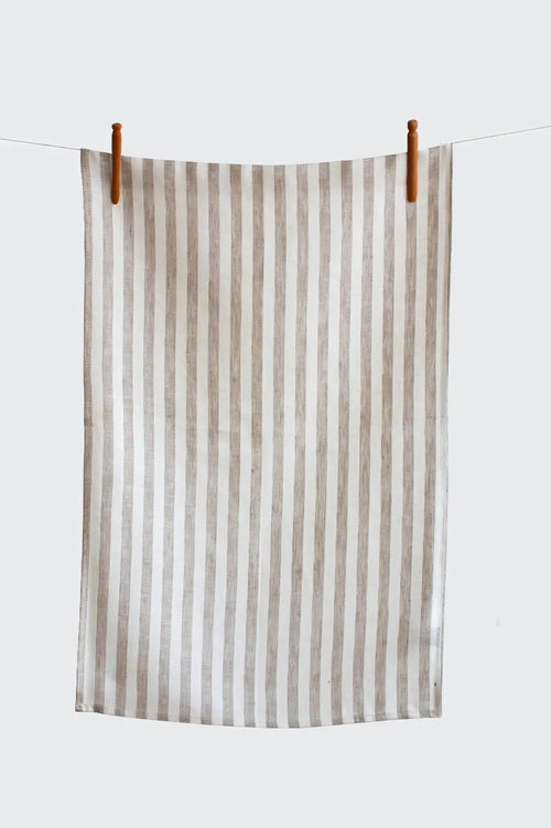 Striped towel hanging on a clothesline against a white background