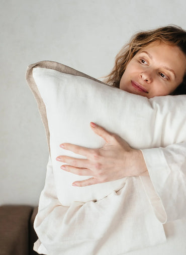 Soft and cozy Adelaide Pillow Cover with linen texture and elegant trim, embraced for ultimate comfort