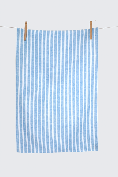 Blue and white striped towel hanging on a clothesline against a light gray background