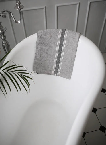 Casa Linen Guest Towel elegantly draped over a freestanding bathtub featuring soft stonewashed linen