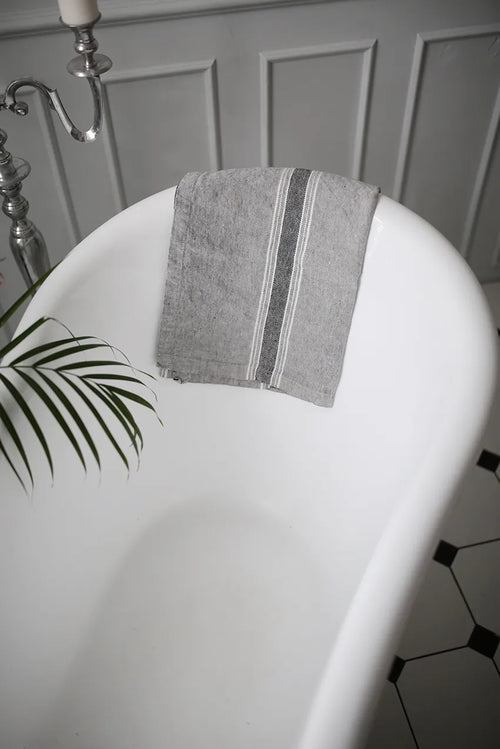 Casa Linen Guest Towel elegantly draped over a freestanding bathtub featuring soft stonewashed linen