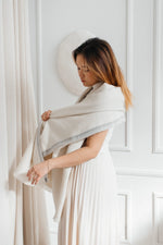 Woman wearing Jutland Baby Alpaca Throw – soft and warm.