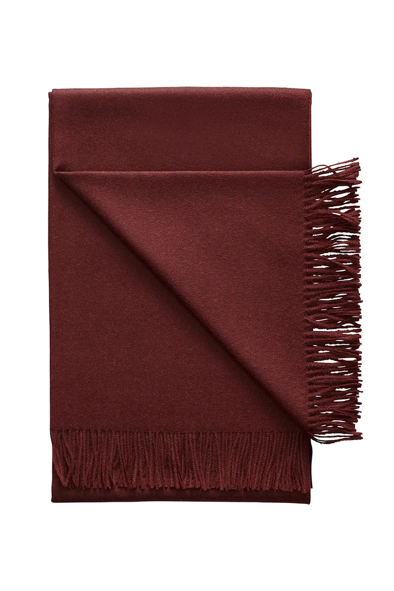 Deep chestnut Paris Baby Alpaca Throw, neatly folded with fringe, showcasing its rich color and dense weave