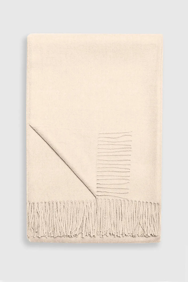 Paris Baby Alpaca Throw neatly folded with visible fringes, showcasing soft texture.